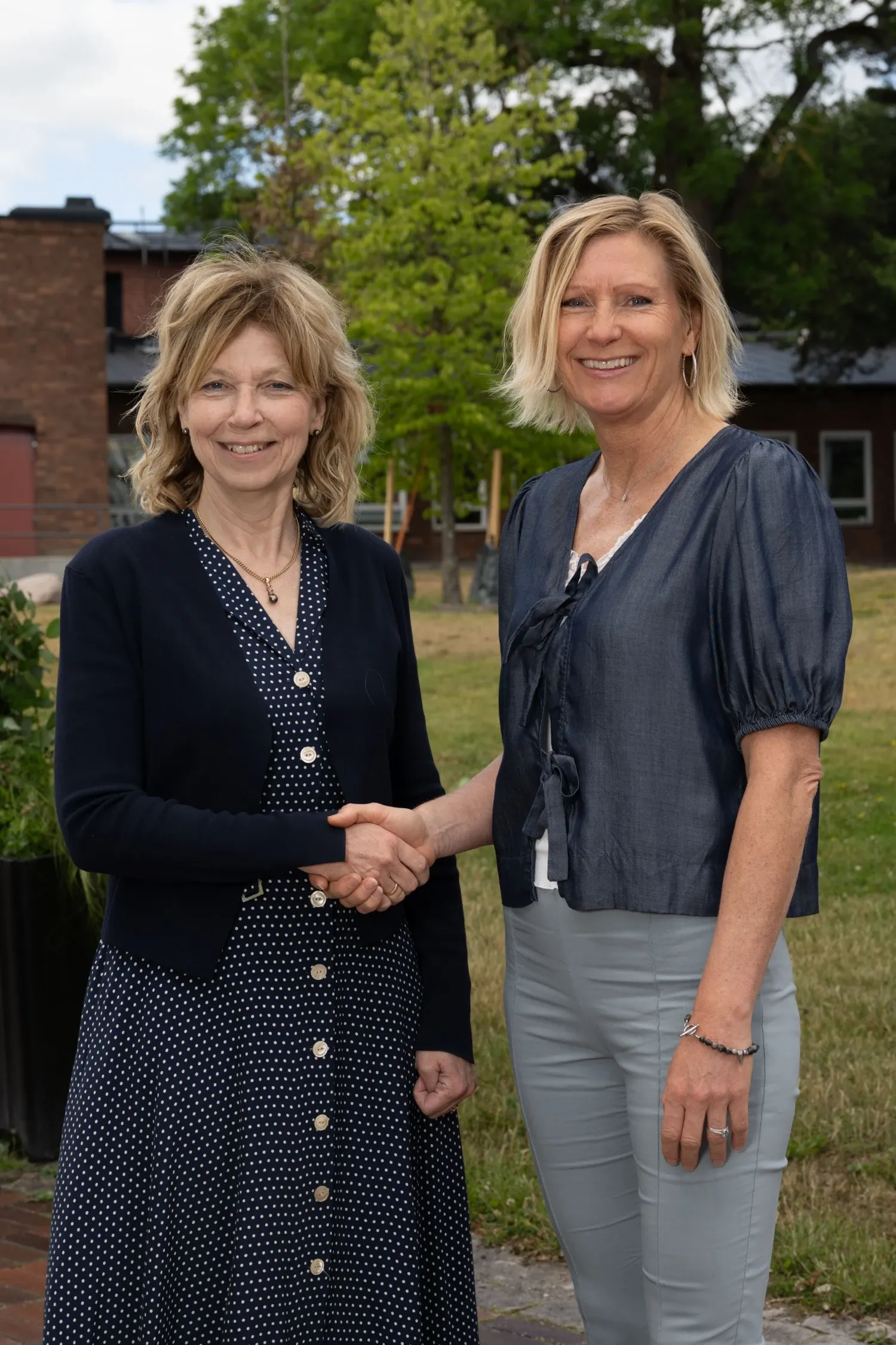 Two women shaking hands