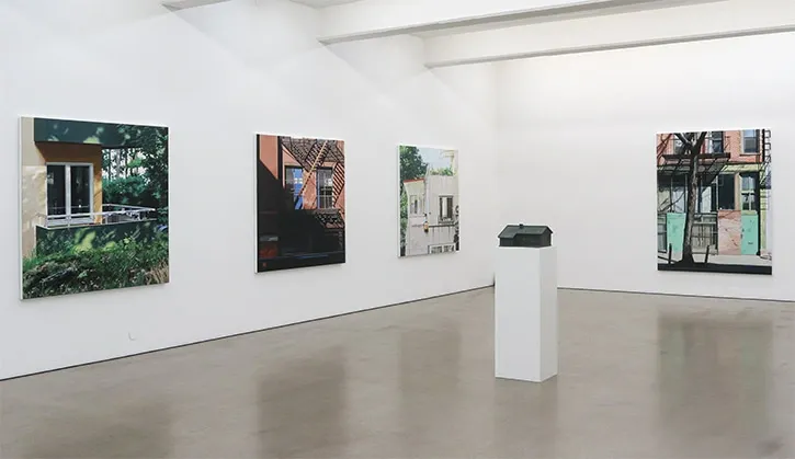 White open room with art pieces on the walls.