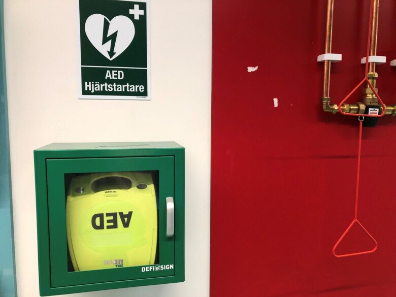 Photo of a defibrillator on a wall.