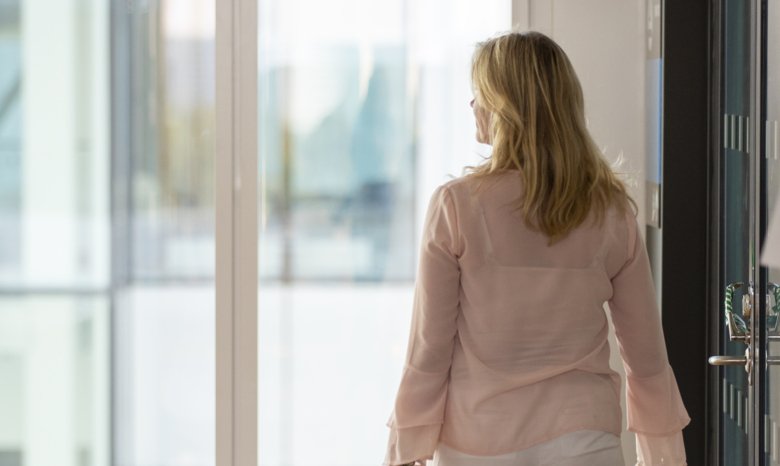 Woman walking in corridor.