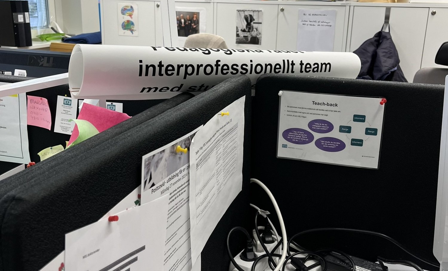 A poster with the text Interprofessional team placed in an office space