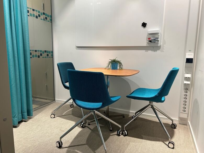 Image of table and three chairs in a conversation room in ANA Futura.