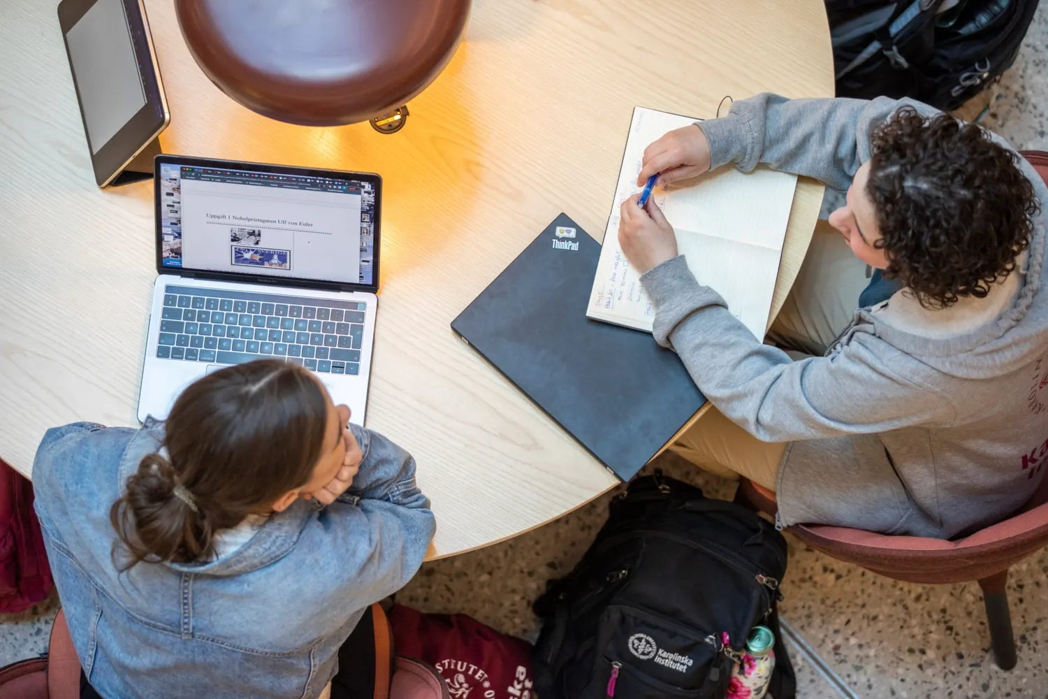 Students hanging out indoors on campus.