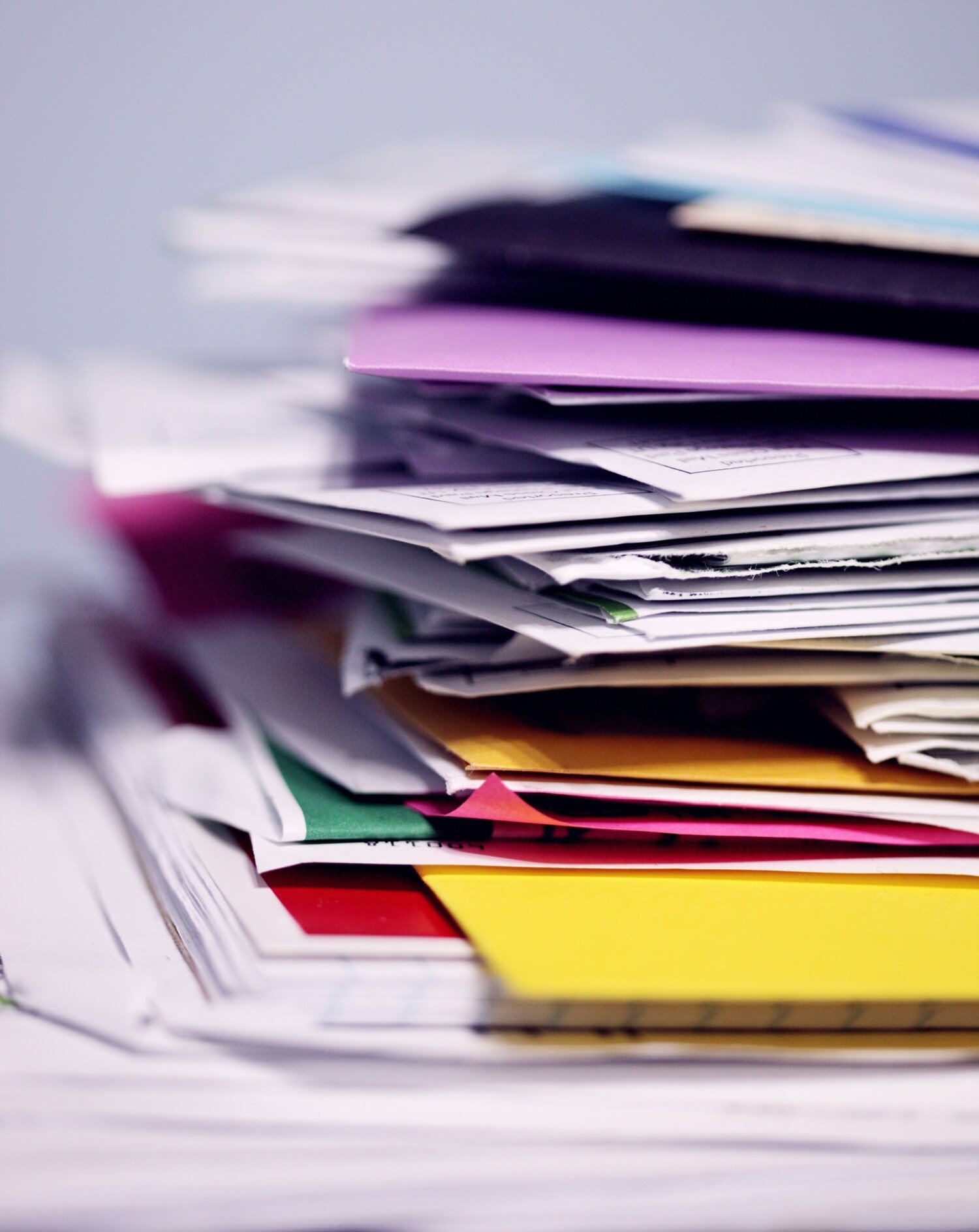 Data on a digital screen and piles of paper.