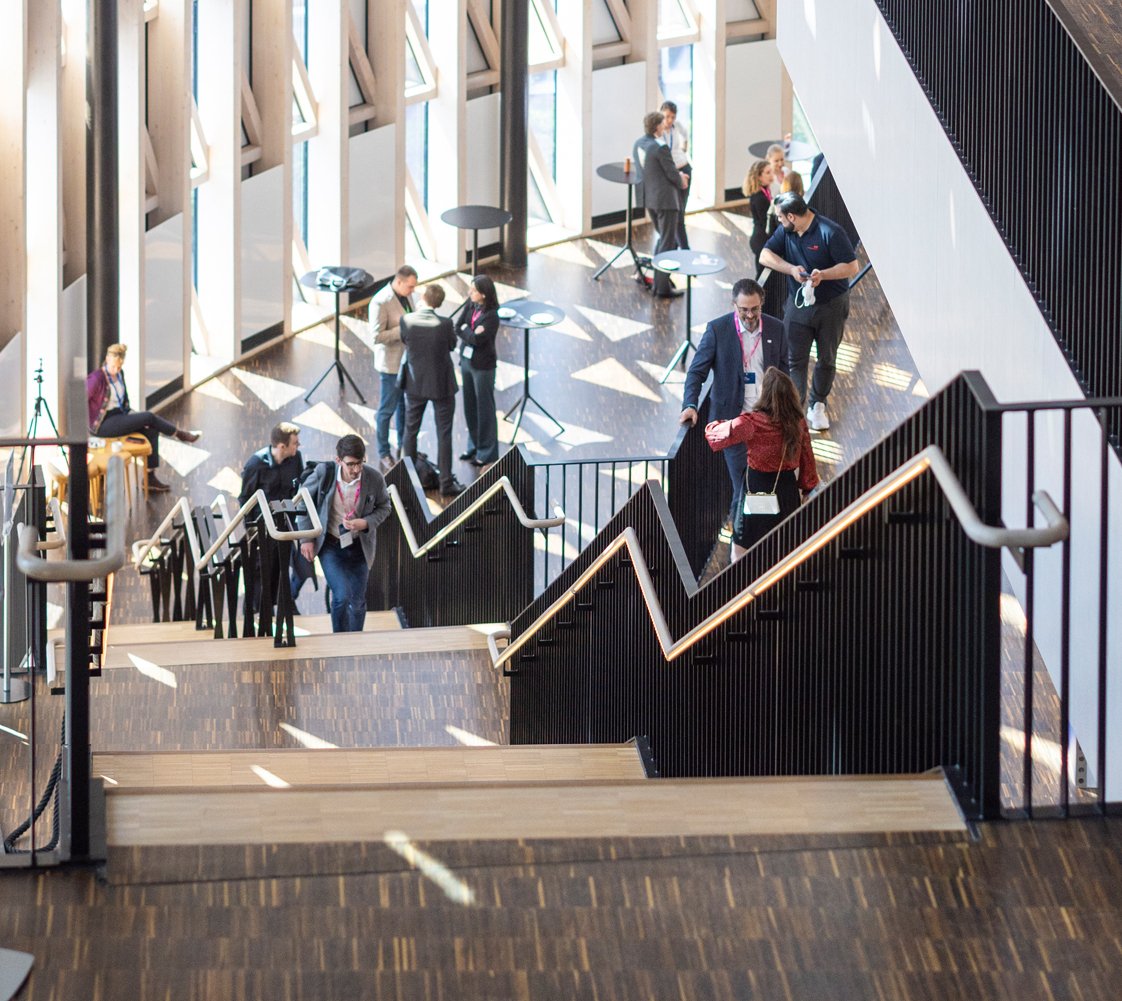 People walking in the stairs inside the aula medica.