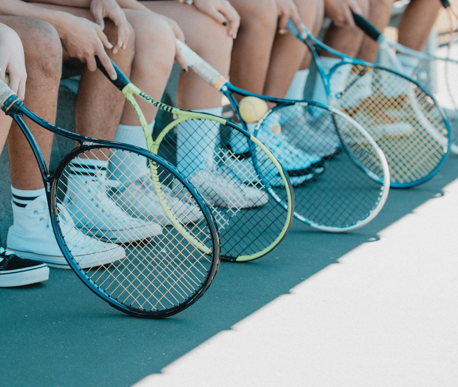 People with tennis rackets.