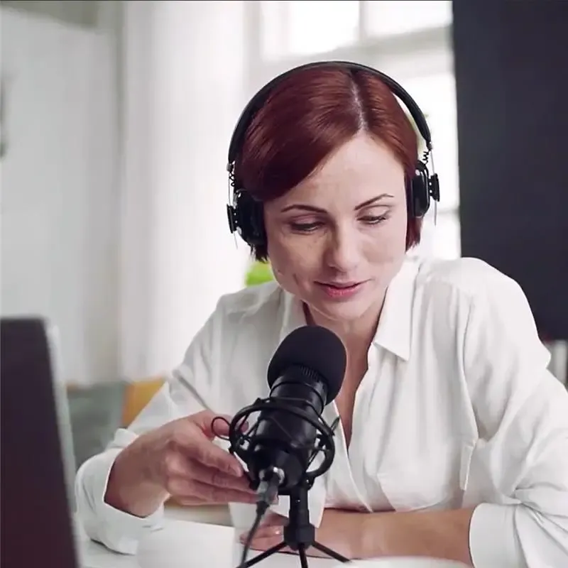 Woman in front of computer recording her voice