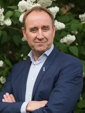 Portrait of Carl Johan Sundberg standing in a garden crossing arms