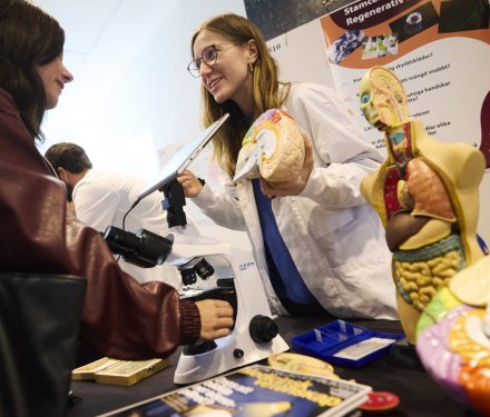 Woman holding a model of the human brain.
